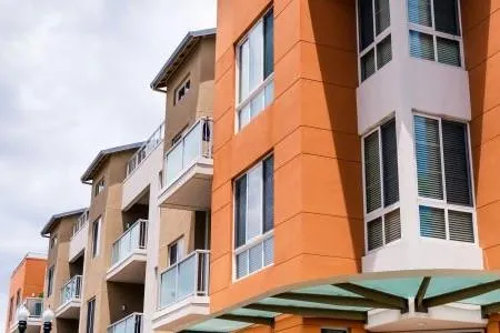 Row of modern apartments reflecting Harvest Real Estate Group's proficiency in property management.