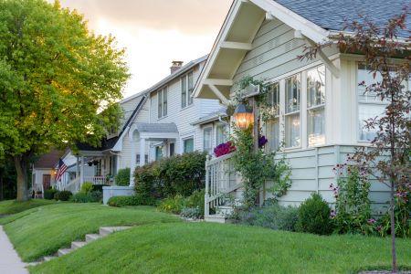 Beautiful home bathed in sunset light in a charming neighborhood, symbolizing Harvest Real Estate Group's expertise in home buying and selling.